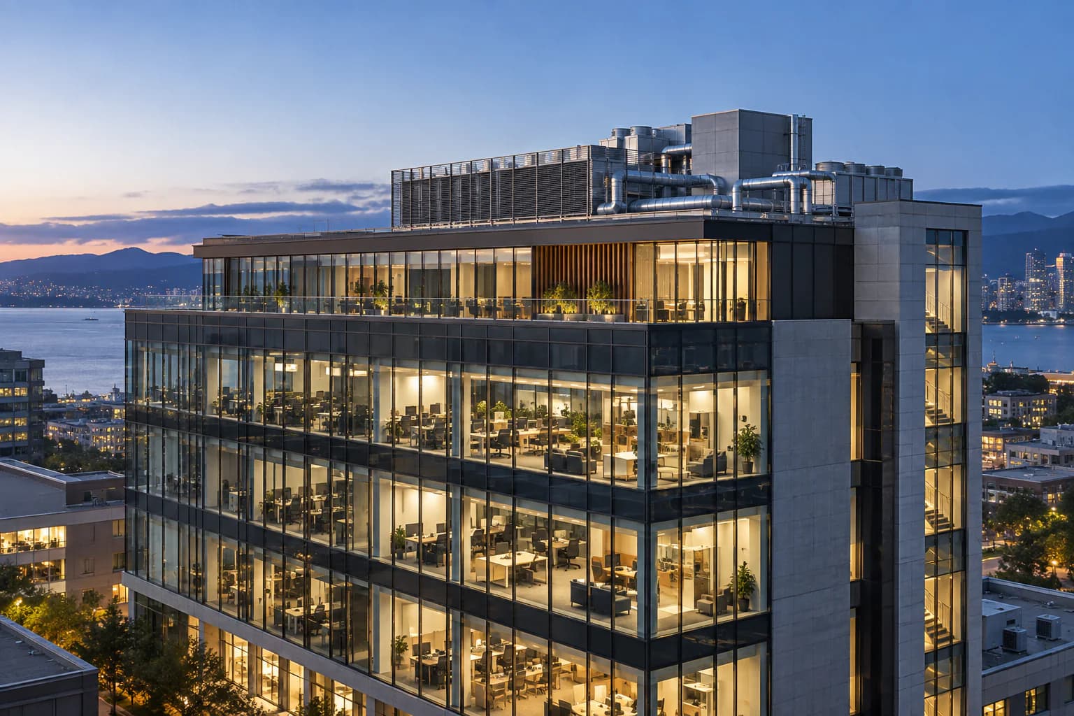 Commercial building with integrated rooftop mechanical systems at blue hour